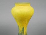 a yellow vase that is sitting on a table