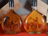 three bottles of alcohol with pictures of people in them