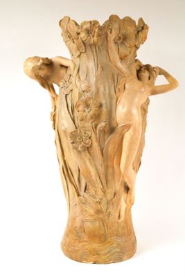 a large vase with a statue of a woman on it
