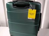 a green suitcase with a yellow tag on it