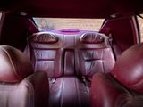 the back seats of a car are covered in maroon leather