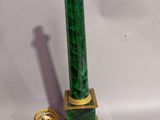 an image of a green and gold lamp on a white background