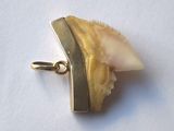 gold plated pendant with a large piece of yellow and white stone