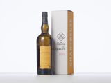 a bottle of whisky sitting next to a box on a table