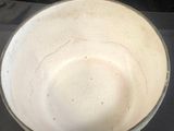 a white bowl that is sitting on a black table