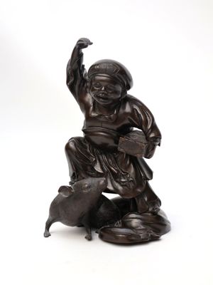 bronze figurine of a boy with a dog and a bowl of water