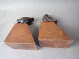 pair of wooden bookends with a bird on top of them