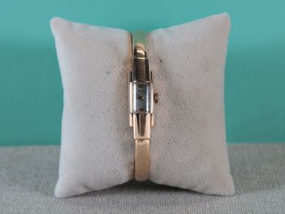 a close up of a ring on a pillow on a table