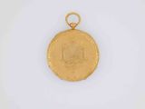 a close up of a gold coin on a white surface