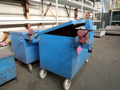a blue dumpster sitting in the middle of a warehouse