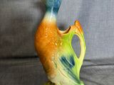 a ceramic bird that is sitting on a table