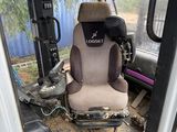 a seat in the back of a bus that is dirty