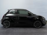 the small black car is parked on the concrete floor