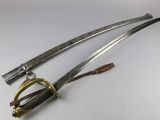 two old swords are laying next to each other on a white surface