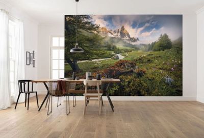a dining room with a table and chairs and a large painting on the wall