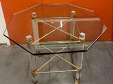 une table en verre avec un cadre en métal et un plateau en verre