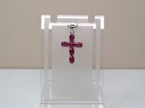 a red cross on a clear display case on a table