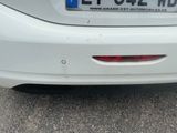 the rear end of a white car with a license plate on it