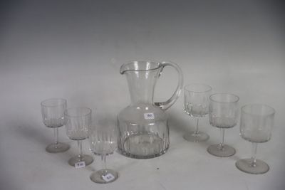 a lot of wine glasses and a pitcher on the table