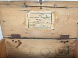 an old wooden box with a label on it