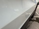 a white car parked in a parking lot next to a building