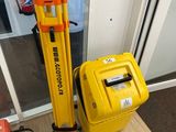 a yellow suitcase and a yellow tripod sitting next to each other