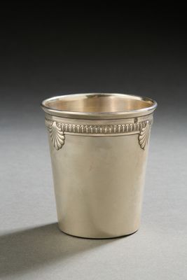 a silver cup that is sitting on a table