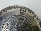 a silver plate with a picture of a man on it