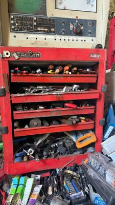 un établi rouge sur lequel sont posés des outils, dans un garage