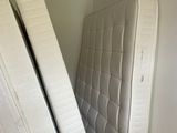 two mattresses stacked on top of each other in the corner of a room