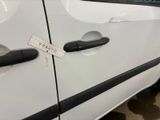 a sticker on the door handle of a white car