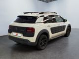 the back of a white car with a black roof rack on it ' s roof
