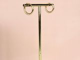 a white marble stand with two gold rings on top of it