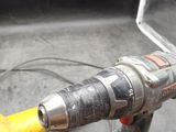 a corded drill that is sitting on top of a table