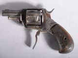 an old revolver with a wooden handle on a white surface