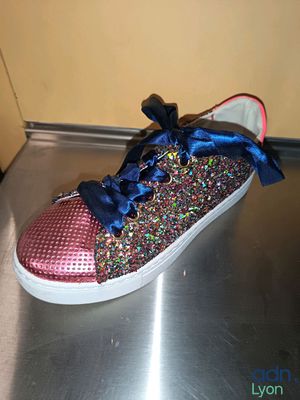 un gros plan sur une paire de chaussures posée sur une surface métallique