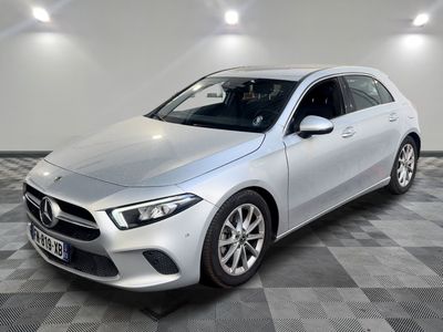 a silver mercedes cla parked on a checkered floor