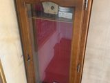 a grandfather clock sitting on top of a wooden cabinet
