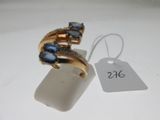 an image of a gold ring with blue stones and a price tag