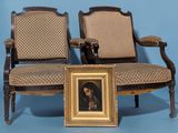two chairs with a picture of a man sitting on one of them