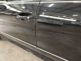 a black car with a chrome door handle and a black door handle