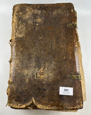 an old book sitting on top of a table with a tag on it
