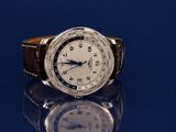a close up of a wrist watch on a blue surface