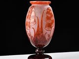a glass vase with a design on it on a table