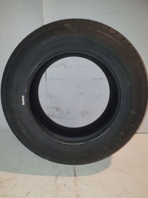 tires are lined up on a white surface in a room