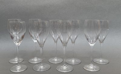 six empty wine glasses lined up in a row on a table