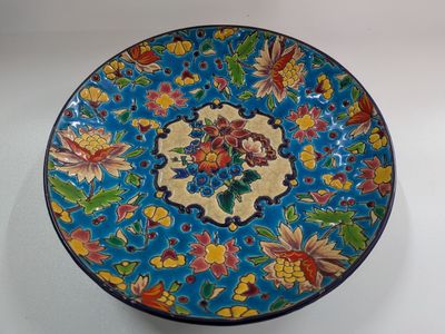 a blue plate with a floral design on it