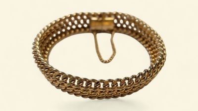 une image d'un bracelet en or sur fond blanc
