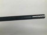 a close up of a hand holding a gun with a black barrel