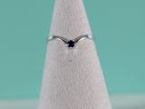 a close up of a ring on a white cone with a blue background